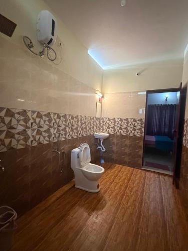 a bathroom with a toilet and a sink at Sea lumina in Varkala