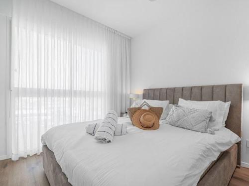 a bedroom with a large bed with white sheets and pillows at Redsearent suite with pool view 16 in Eilat