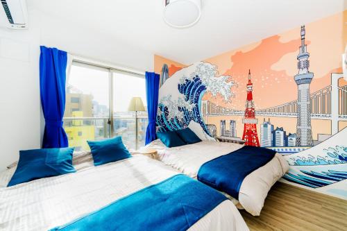 two beds in a room with a mural of a wave at LEON RESORT HOTEL Max5-10people Sumiyoshi 8min Skytree 10min Kinshicho Taxi1meter in Tokyo