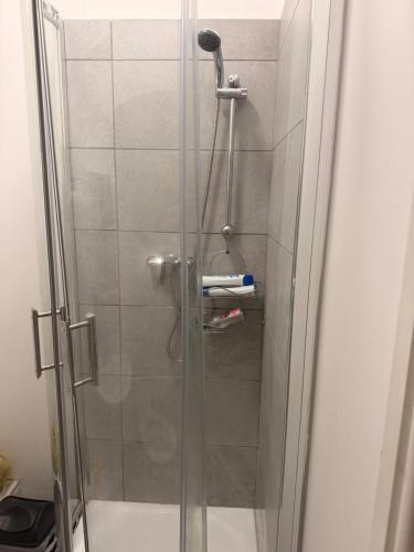 a shower with a glass door in a bathroom at Your Cozy Colne Getaway Free parking and views in Colne
