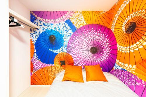 a bedroom with colorful umbrellas on the wall at LEON RESORT HOTEL Max5-10people Sumiyoshi 8min Skytree 10min Kinshicho Taxi1meter in Tokyo