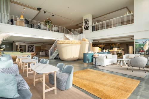 a lobby with tables and chairs and a pool table at Hotel Terraverda at Empordà Golf Resort in Torroella de Montgrí