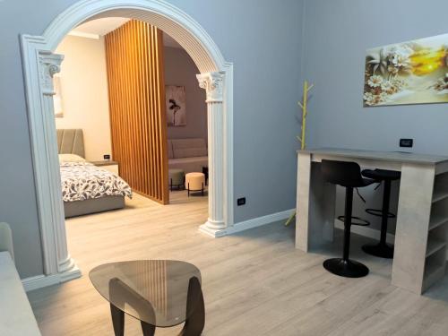 a bedroom with a bed and a desk with a chair at My Daily Home in Fier
