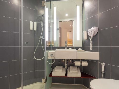 a bathroom with a sink and a mirror at ibis Chennai Sipcot - An Accor Brand in Chennai