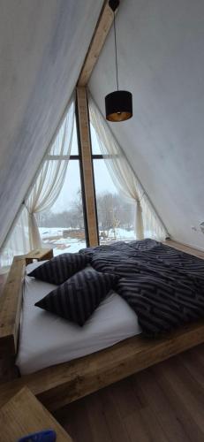 a bedroom with a bed in a tent at Wild Hill Apuseni in Gârda de Sus