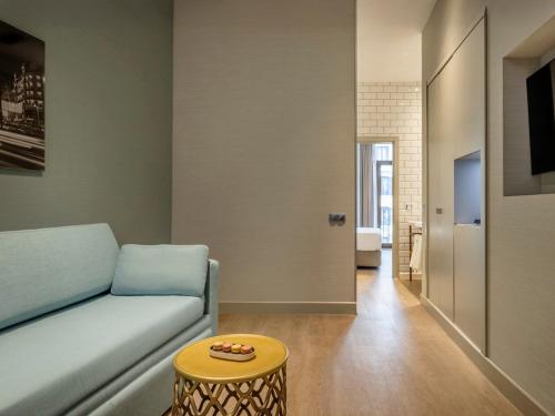 a living room with a couch and a table at Regente Hotel in Madrid