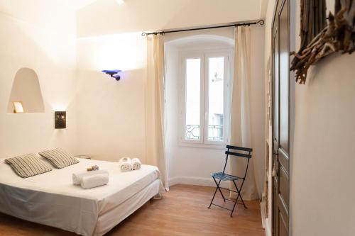 a bedroom with a bed and a chair and a window at Casa Marina in Saint-Florent