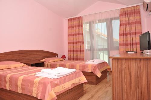 En eller flere senge i et værelse på Hotel Jaky SPA Complex