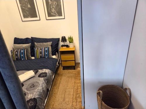 a living room with a blue couch and a table at Crystal Baltic Studio Gdańsk self check in - 24h in Gdańsk