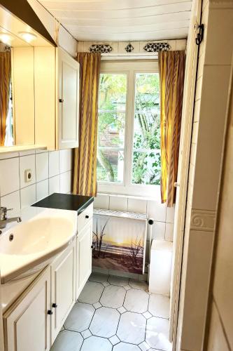 a small bathroom with a sink and a window at Ferienhaus-„Alte-Schmiede“ in Westerland