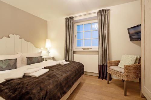 a bedroom with a large bed and a window at Listend Blick in List