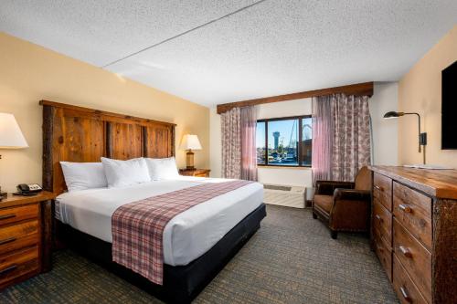 a hotel room with a bed and a window at Lodge of the Ozarks in Branson