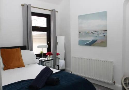 a bedroom with a bed and a window at Limewood Townhouse in Londonderry County Borough