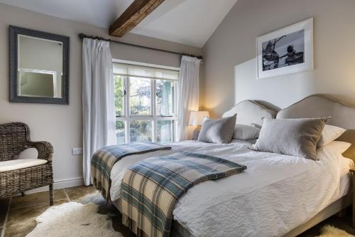 a bedroom with a bed and a window at The Cottage in Steeple Bumpstead