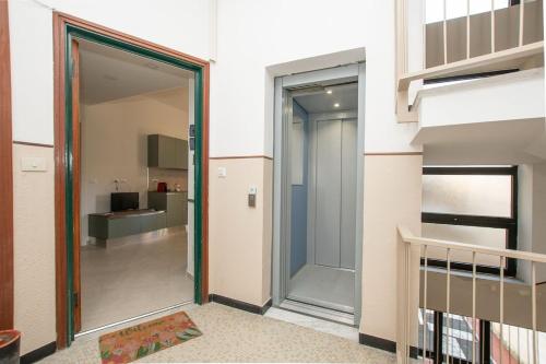 an open door to a hallway with a living room at Finalpia suite con box auto e deposito bici in Finale Ligure