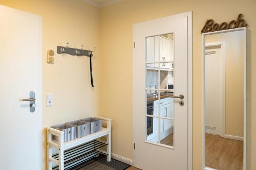 a door leading into a room with a kitchen at Norderhoog-Whg-45-2-OG-O-Wohnung-45 in Westerland