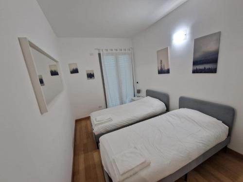 two beds in a room with white walls at Il Rifugio di Boccadasse in Genoa