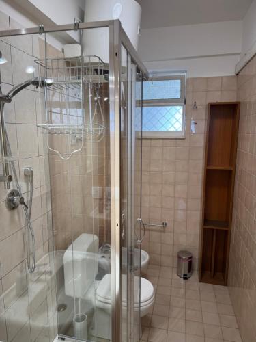 a bathroom with two toilets and a glass shower at A montagna e u mari home in Aci Castello