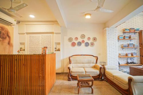 a living room with a couch and a chair at Hotel Ishan - A Ganges Riverside Retreat by Salvus in Rishīkesh