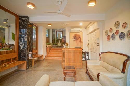 a living room with a couch and a chair at Hotel Ishan - A Ganges Riverside Retreat by Salvus in Rishīkesh