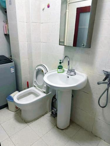 a bathroom with a sink and a toilet at Private room on the 6th floor in Beijing