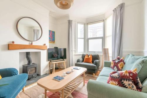 a living room with a blue couch and a table at Arty House with Garden in Central Bristol in Bristol