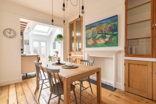 a kitchen and dining room with a table and chairs at Arty House with Garden in Central Bristol in Bristol
