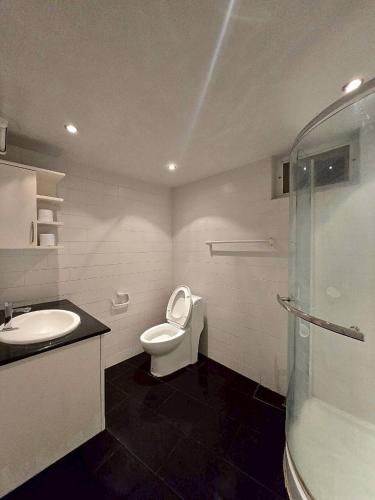 a bathroom with a toilet and a sink and a shower at Red House 12 in Ban Nong Pru