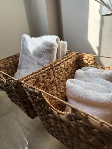 a basket filled with towels in a bathroom at Sunny apartment in Serres