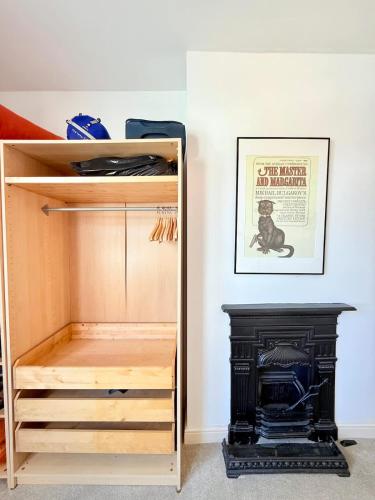 a wooden closet with a stove in a room at Perfect City Flat for Leisure & Work stays in Bristol