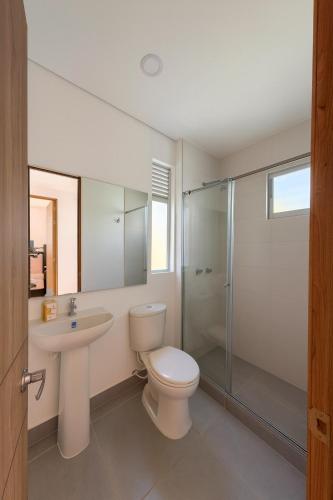 a bathroom with a toilet and a sink and a shower at Casa Bethel 92 in Ricaurte