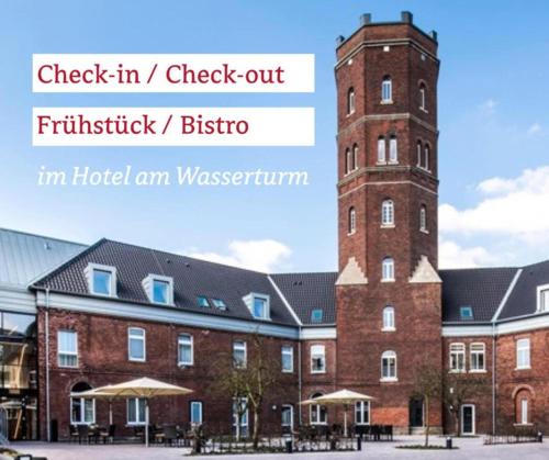 a large brick building with a clock tower at Kloster-Quartier in Münster