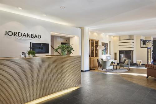 a lobby of a hotel with a reception desk at Dorint Parkhotel Jordanbad in Biberach an der Riß