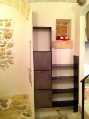 a room with a hallway with a staircase and a door at L' Edera in Fasano