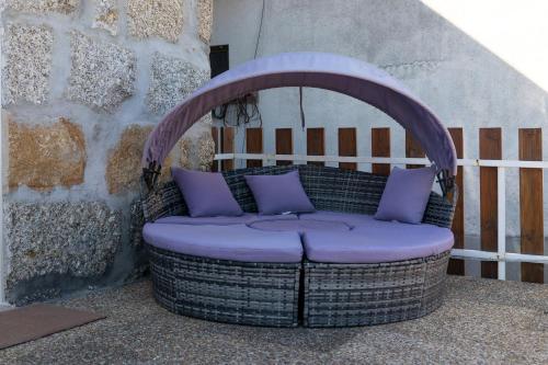 a purple wicker chair sitting on a patio at Quinta Baião, Douro Valley in Santa Cruz do Douro