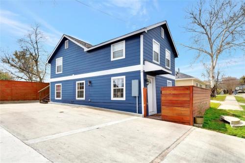 a blue house with a driveway at The Gawdy Den with Fast WIFI 2 minutes from Downtown Houston! in Houston