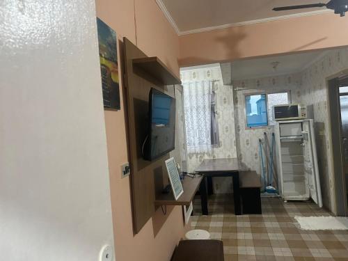 a small kitchen with a table in a room at Kitnet Cantinho 26 in Mongaguá