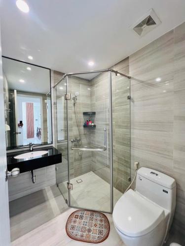 a bathroom with a shower and a toilet and a sink at Youyi Home in Thuan An