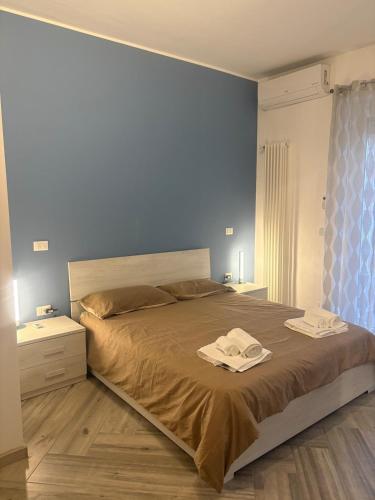 a bedroom with a bed with two towels on it at Pella House in Airasca