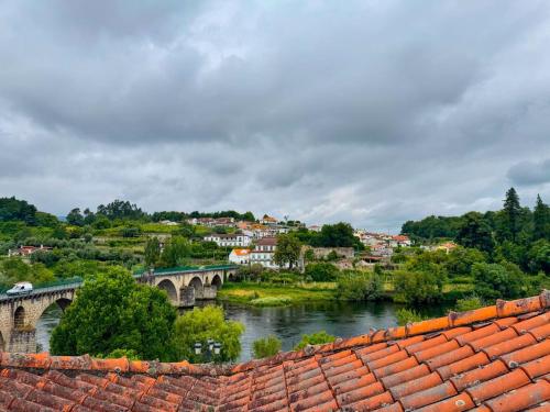 a view of a bridge over a river and a town at Apartamentos Fonte Velha in Ponte da Barca