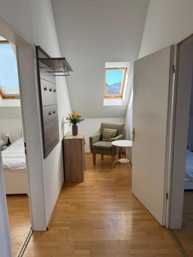 a attic room with a bed and a chair at Helle Dachgeschoßwohnung am Laurentiusplatz in Wuppertal