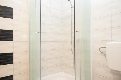 a shower in a bathroom with a toilet at Rooms Garden Zagreb Airport in Velika Gorica