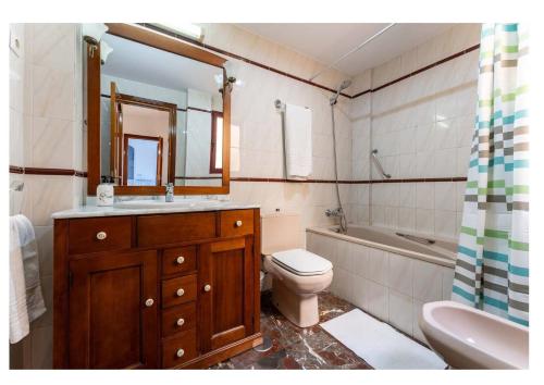 a bathroom with a sink and a toilet and a tub at Urb. Lubina Sol in Mijas Costa