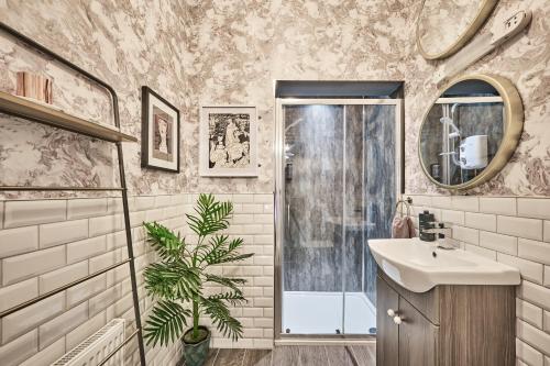 a bathroom with a sink and a shower at Art House in Derry Londonderry