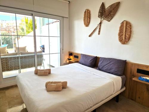 a bedroom with a bed with two teddy bears on it at La Cala de Mijas, groundfloor 2 bed apartment steps away from the beach in Mijas Costa