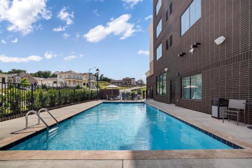 a swimming pool in front of a building at Homewood Suites By Hilton Madison Huntsville in Madison