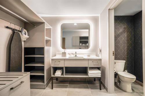 a bathroom with a sink and a toilet and a mirror at Homewood Suites By Hilton Madison Huntsville in Madison