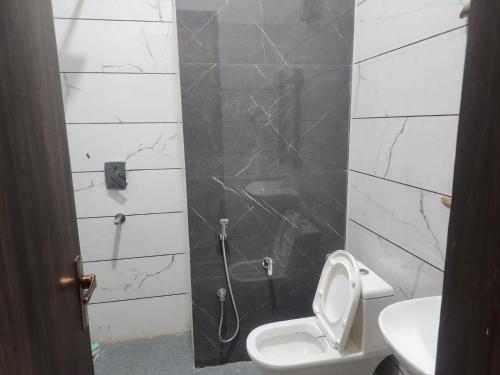 a bathroom with a shower with a toilet and a sink at pearl green's in Anandpur Sāhib