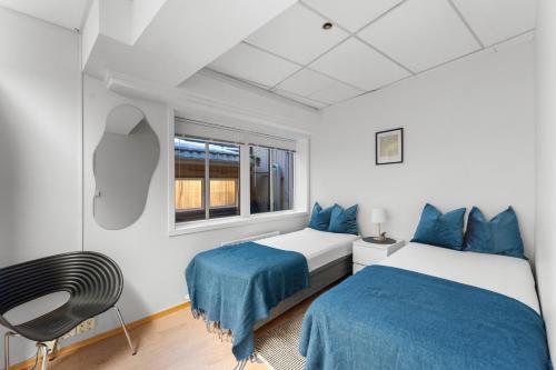 a bedroom with two beds and a window at Tromso Downtown Apartments - Main Street in Tromsø