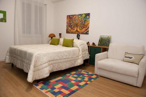a bedroom with a bed and a chair at via Minzoni 26 in Cosenza